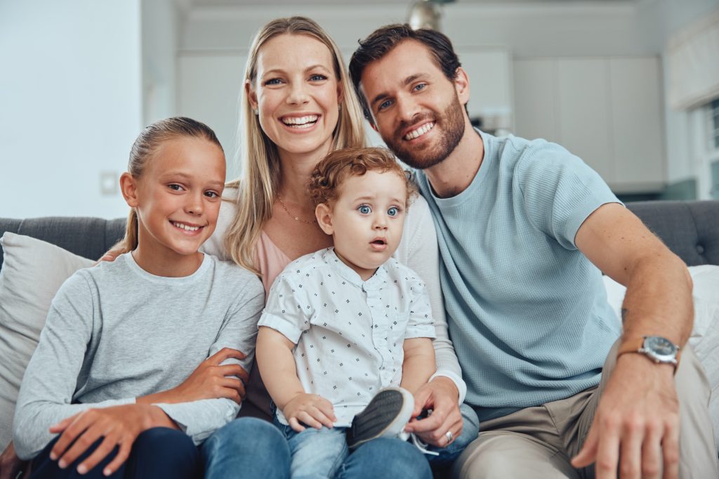 Happy, family and sofa portrait with kids at home in Australia for bonding and togetherness. Family